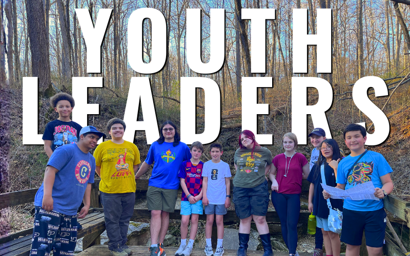 Image of children standing in front of nature with text "Youth Leaders" behind them.