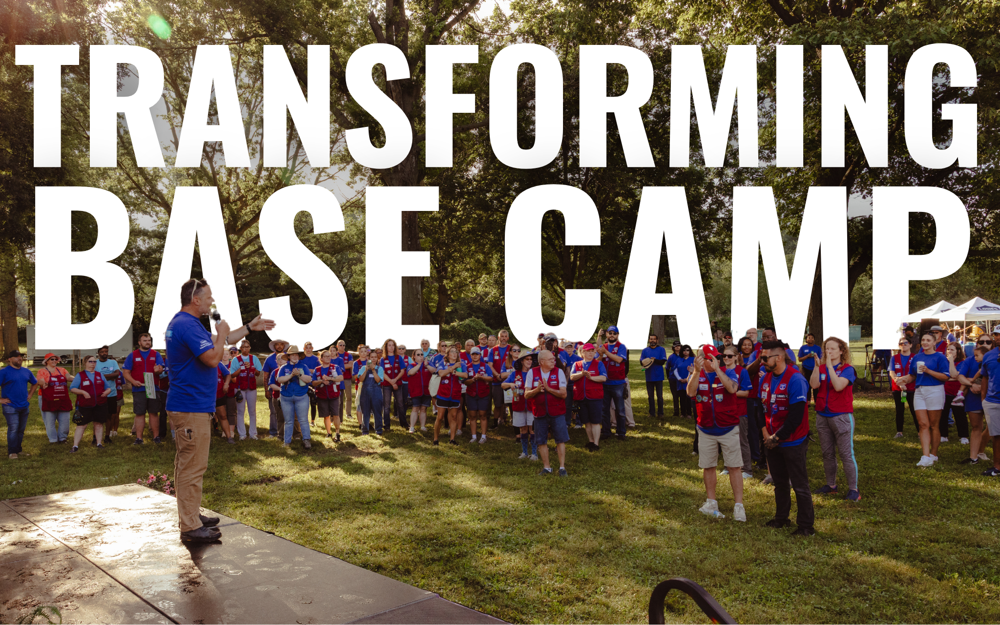 Image of man standing on stage in front of an audience, with "Transforming Base Camp" text embedded in the background.